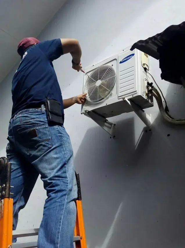 Technician installing an outdoor air-conditioning unit