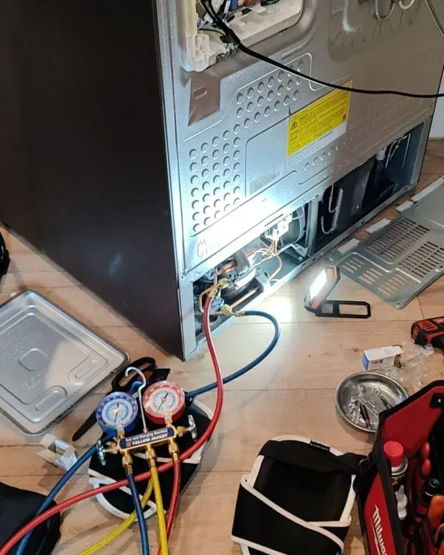 Gauges and tools connected to a refrigerator during fault diagnosis
